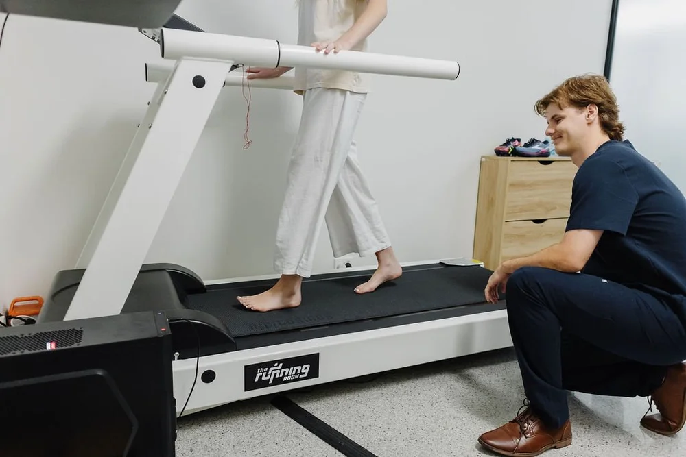 A podiatrist watching a patient walk on the clinic treadmill