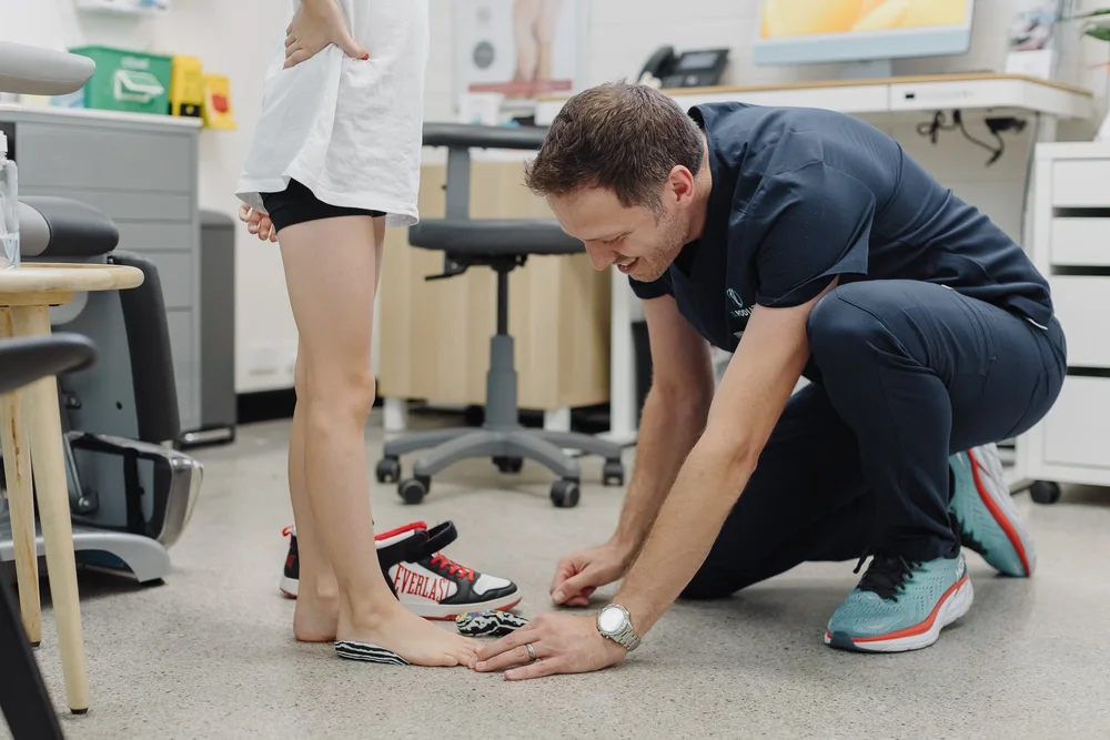JS Podiatry podiatrist assessing a young patient's feet at the East Perth clinic