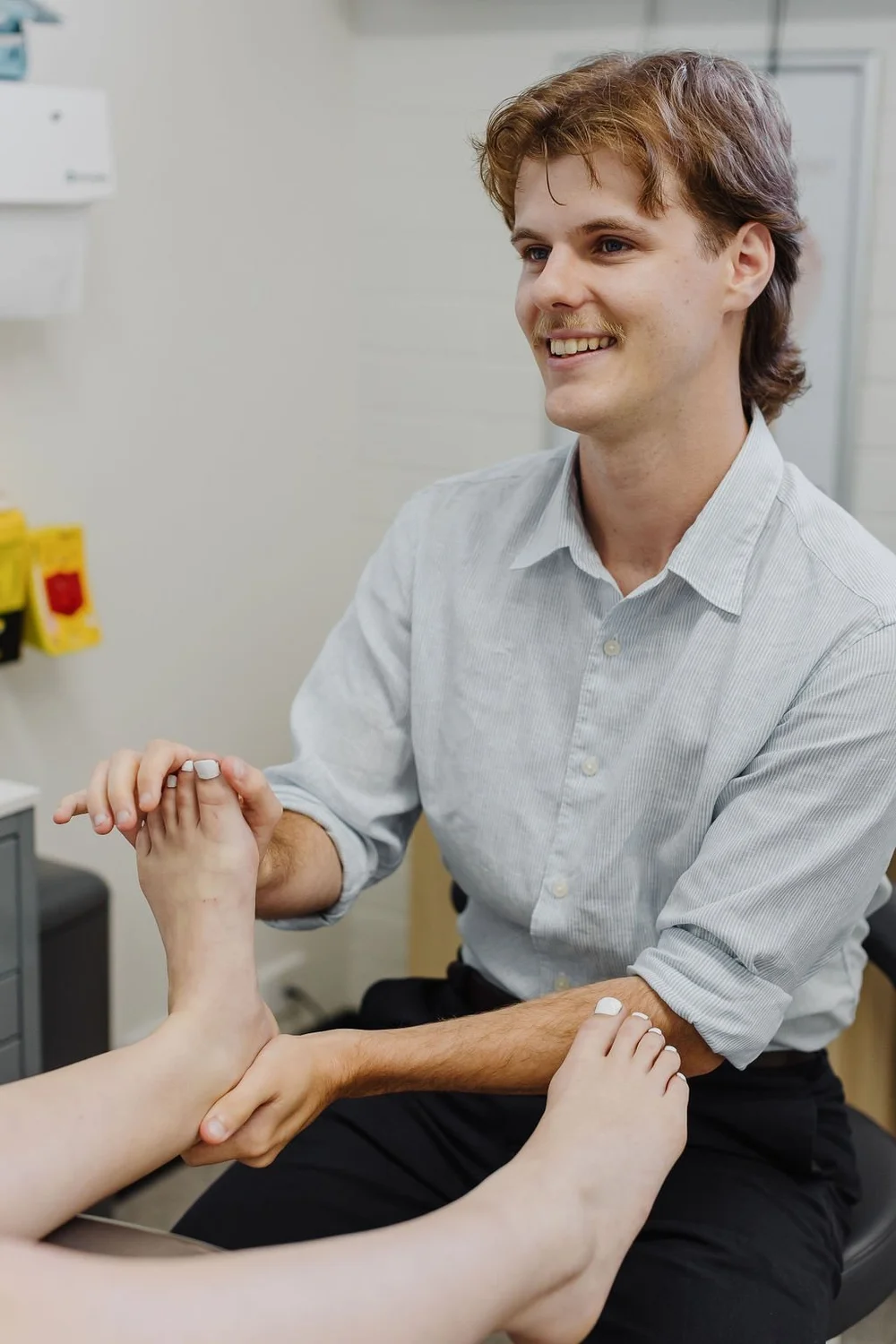 Podiatrist assessing a patient's foot before treatment at JS Podiatry