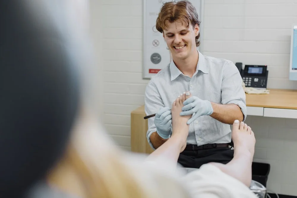 A podiatrist assessing a patient's heel and arch