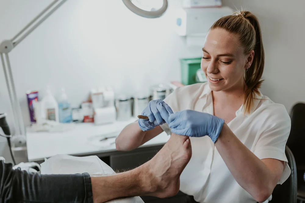 A podiatrist carrying out nail and skin care in the East Perth clinic