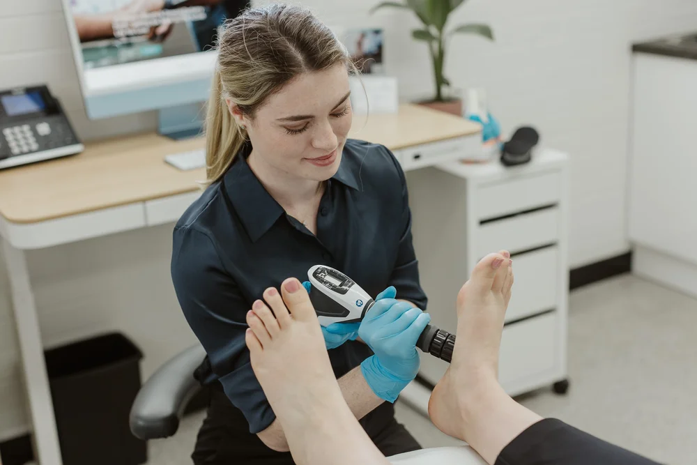 A podiatrist treating a patient's foot in the East Perth clinic